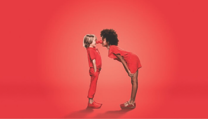 Two kids touching red noses for Red Nose Day