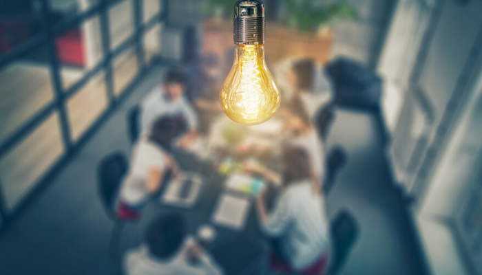 lightbulb over a team meeting